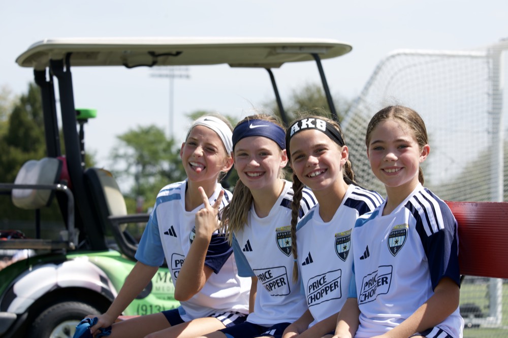 SBV players smiling together on the bench at a game